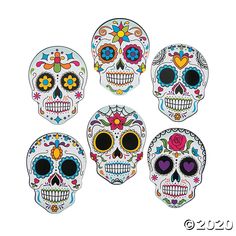 six sugar skulls with different colors and designs on the front, one for each day of the dead