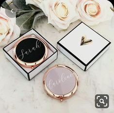 three personalized jewelry boxes sitting on top of a marble table next to white flowers