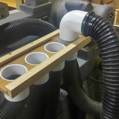 a couple of pipes that are connected to some kind of device in a machine shop