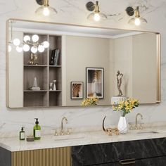 a bathroom with marble counter tops and gold accents on the mirror above it is a vase full of yellow flowers