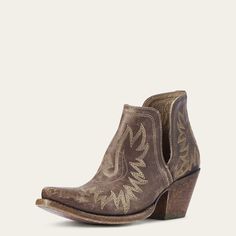 a pair of brown cowboy boots with embroidered designs on the side and wooden heeling