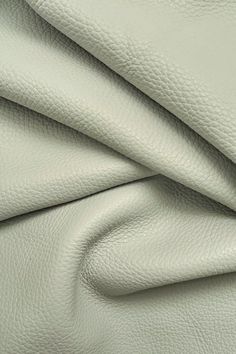 white leather textured up close to the surface with no visible stitching on it