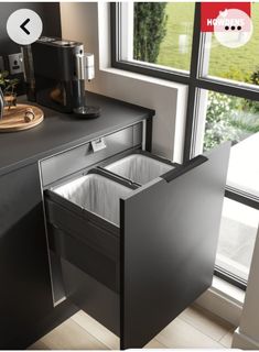 an open dishwasher sitting next to a window