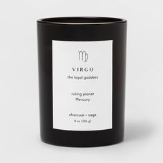 a black candle with a white label on the front and side, which reads virgo