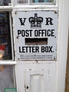 an old post office letter box with a crown on it's front door is displayed