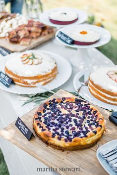 a table topped with lots of different types of cakes and pies on top of plates