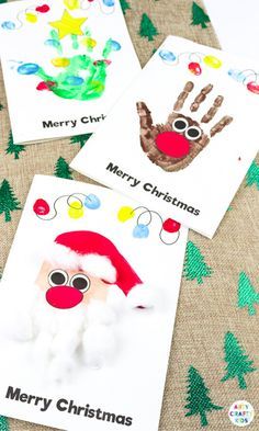 three christmas cards with handprints on them and santa claus's hat in the middle