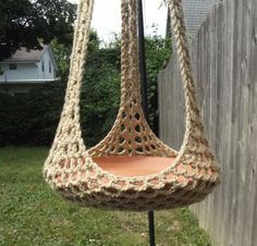 a crocheted hammock hanging from a pole