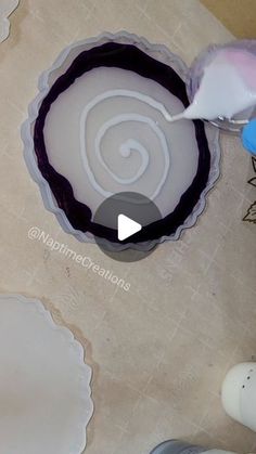 a person is using a brush to paint the inside of a cake pan with icing