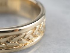 The workmanship of this vintage band is incredible. Decorative braid work wraps around the center, free-floating in a channel of polished gold. Handsome alone or worn with another piece, this features a smooth and comfortable inner surface and is sized and styled to be suitable for a larger hand. Metal: 14K Yellow Gold Width of Band: 6.7 mm Height off Finger: 1.8 mm Ring Size: 12.50 Marks: "14K" Stamped on the inside band Vintage Gold Carved Ring, Vintage 14k Gold Engraved Ring Hallmarked, Vintage Handmade 14k Gold Engraved Ring, Vintage Engraved Yellow Gold Cuff Bracelet, Vintage Hallmarked Gold Bracelet, Braided Wedding Band, Braid Patterns, Stacking Bands, Cameo Ring