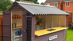 a purple shed with a bar built into it