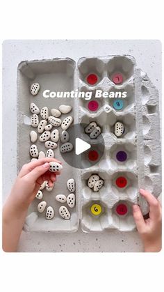 an egg carton filled with lots of different colored eggs and counting beans in it