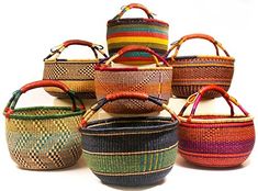 several baskets are stacked on top of each other in different colors and patterns, with handles