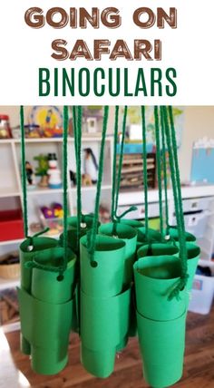 some green plastic buckets hanging from the ceiling with text that reads going on safari binoc