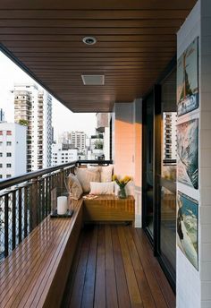 a balcony with wooden flooring and white walls