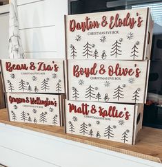 four boxes with christmas decorations on them sitting on a shelf