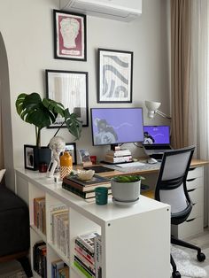 a home office with two computer screens and books