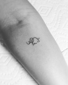 a small elephant tattoo on the arm