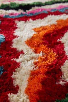 a multicolored rug is laying on the floor