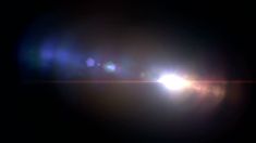 the sun is shining brightly in the dark night sky with lens flares on it