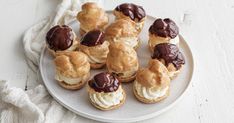 a white plate topped with chocolate covered pastries