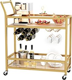 a bar cart with wine glasses and plates on it