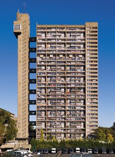 a very tall building with lots of windows and balconies on the top floor