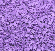 many purple stars are scattered on the ground