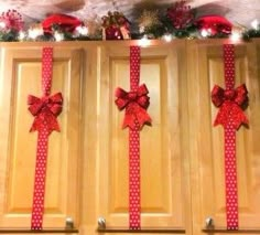 a kitchen decorated for christmas with red bows and lights on the wall above it is an instagram