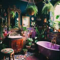 a bath tub sitting next to a sink in a bathroom filled with potted plants