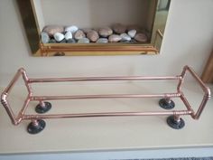 a shelf with some rocks in it on top of a counter next to a mirror