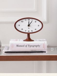 a clock sitting on top of a stack of books