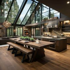 an open kitchen and dining area with wood flooring, large windows, wooden benches, and glass walls