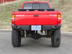 a red toyota truck is parked on the street