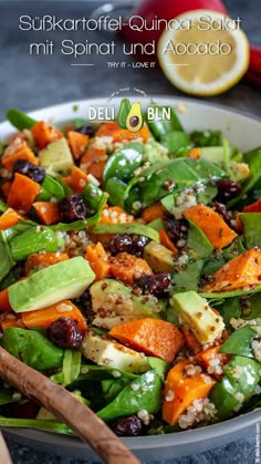 a salad with carrots, avocado and cranberries in a bowl