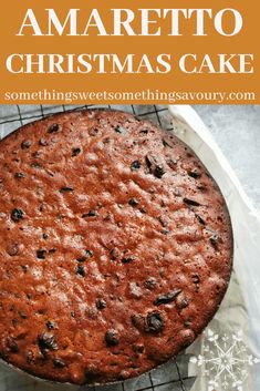 a christmas cake on a cooling rack with the words amarretto christmas cake above it