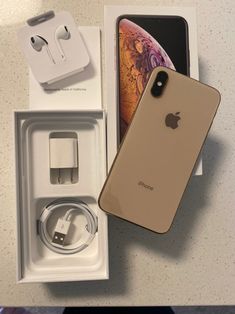 an iphone xr in its box next to the charger