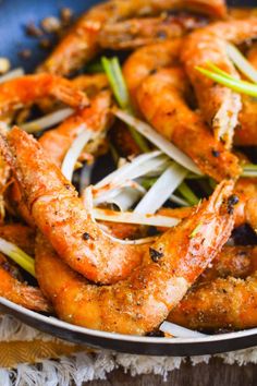 cooked shrimp with onions and scallions in a pan