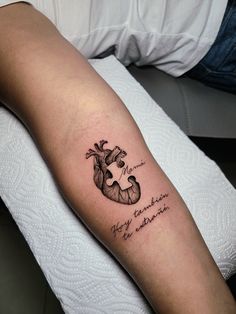 a person with a heart tattoo on their arm