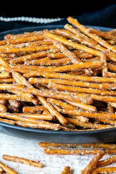 a bowl filled with churros on top of a wooden table