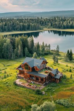 an aerial view of a large house in the middle of a field with trees around it