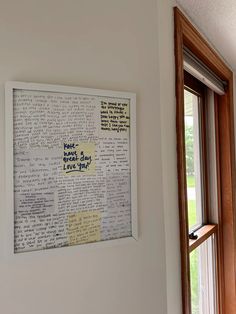 a piece of paper that has been placed on the wall next to a window with some words written on it