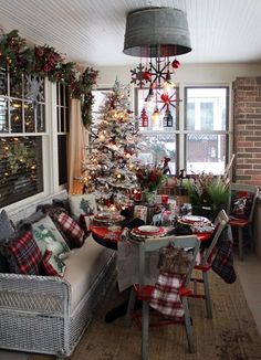 a living room with a christmas tree in the corner and other decorations on the windowsill