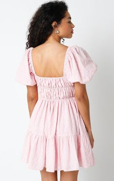 Get ready to feel fabulous in the Kendall Pink Eyelet Puff Sleeve Mini Dress! It's sure to bring a playful and fun vibe to your wardrobe. This puff sleeve mini dress is made from pink and cream pierced eyelet lace fabric, with a smocked corset-inspired bodice, a square neckline, and an attached tiered mini skirt. Style with heels for an elevated look! DETAILS & FIT S: 30" length, 25" waist, 32" bust M: 30.5" length, 27" waist, 33" bust L: 31" length, 29" waist, 35" bust 100% Cotton. Machine wash Feminine Pink Mini Dress With Puff Sleeves, Pink Feminine Puff Sleeve Mini Dress, Flirty Pink Cotton Mini Dress, Flirty Cotton Mini Dress With Short Sleeves, Feminine Pink Mini Length Puff Sleeve Dress, Flirty Short Sleeve Cotton Mini Dress, Cute Pink Puff Sleeve Mini Dress, Cute Pink Knee-length Mini Dress, Feminine Mini Puff Sleeve Dress For Brunch