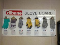 gloves are lined up on the wall in front of a sign that says glove board