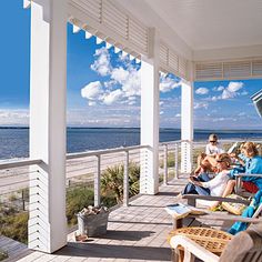 people sitting on the front porch of a beach house