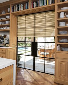 a kitchen with wooden cabinets and sliding glass doors