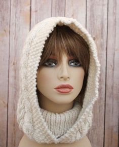 a mannequin head wearing a white knitted hood