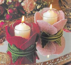 two knitted candles sitting on top of a tray