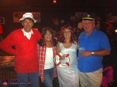 three people standing next to each other in front of a bar wearing costumes and hats